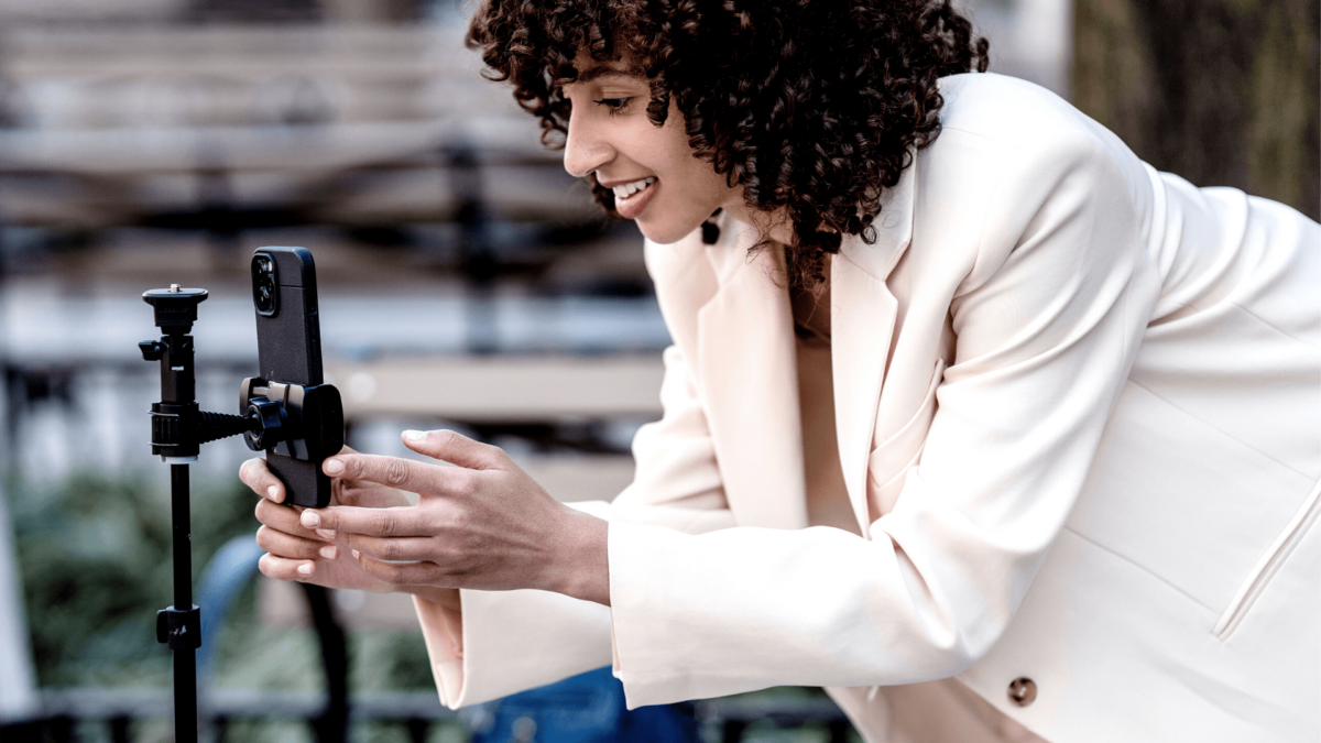 Woman setting up to shoot a video from a phone for b2b content creation